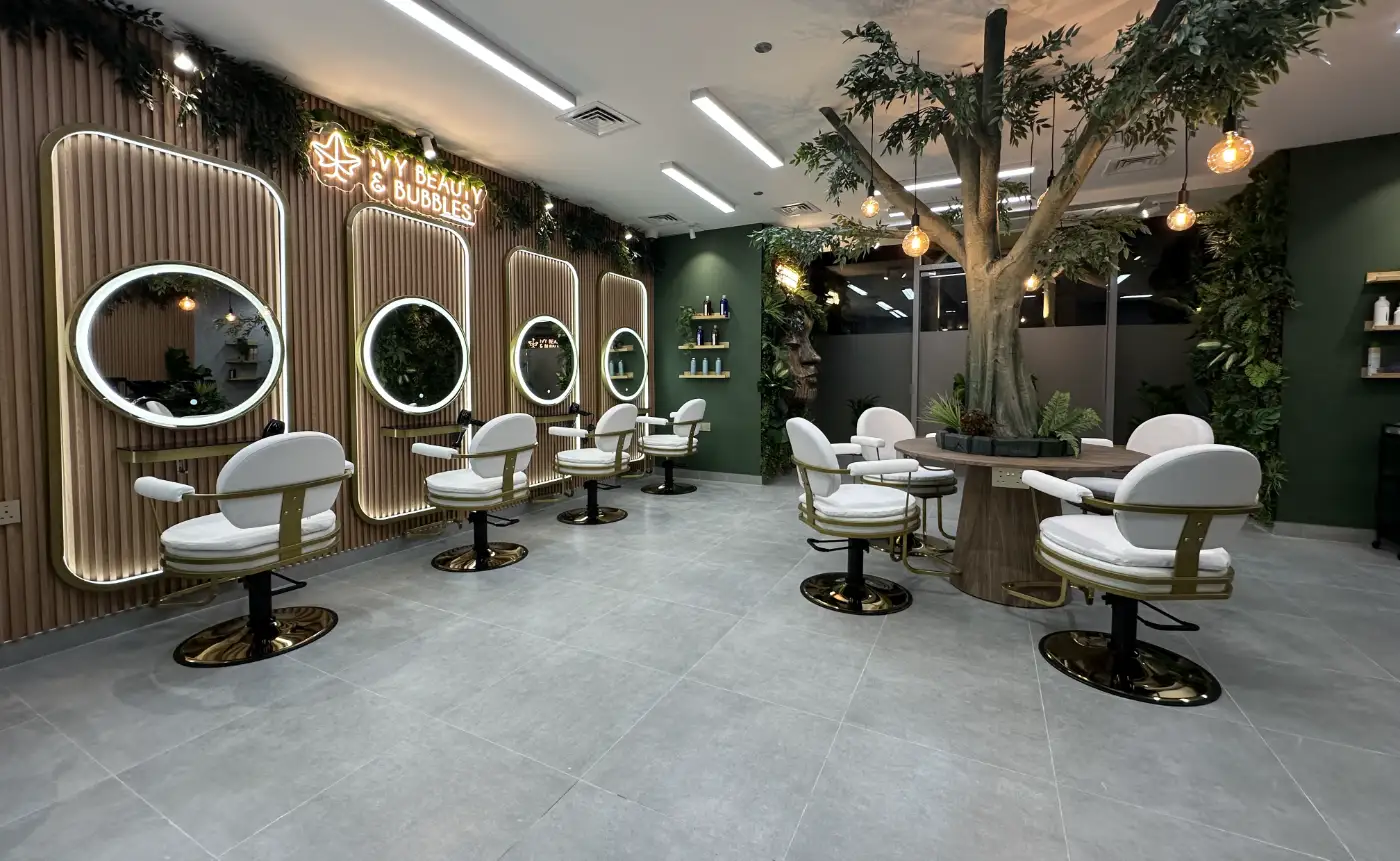 IVY Beauty and Bubbles hair salon with illuminated arched mirrors and an indoor tree